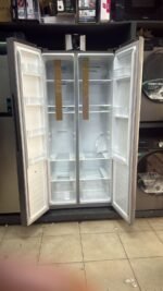 Open empty side-by-side refrigerator in appliance store
