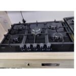 Five-burner black glass gas cooktop with knobs