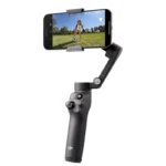 DJI smartphone gimbal filming child playing soccer outdoors