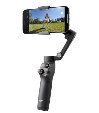 DJI smartphone gimbal filming child playing soccer outdoors