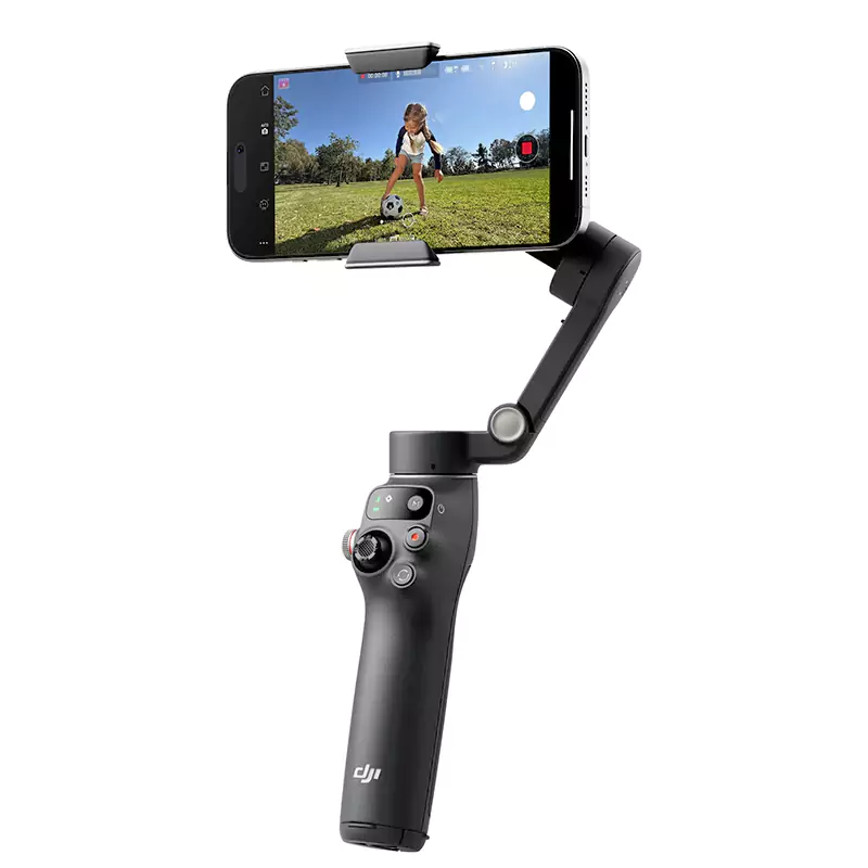 DJI smartphone gimbal filming child playing soccer outdoors